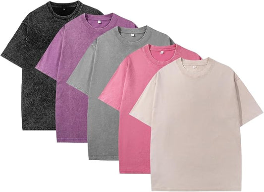 Five plain t-shirts in black, purple, gray, pink, and beige arranged in a row on a white background.