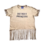 Beige t-shirt with 'Detroit Princess' text and fringe details on a white background