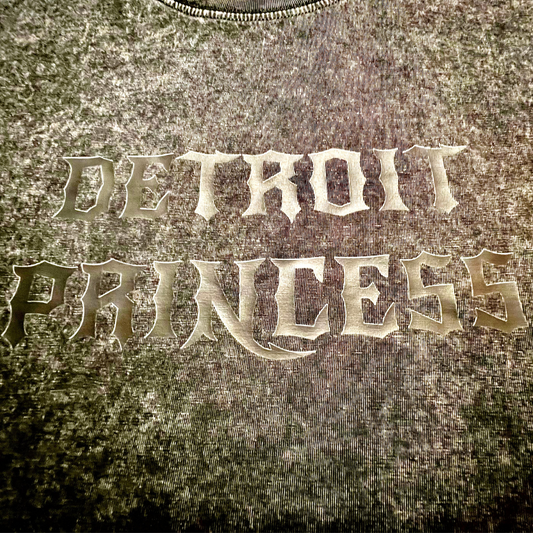 Text 'DETROIT PRINCESS' embossed on a textured surface
